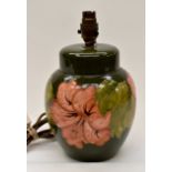 Moorcroft: A lamp base with green ground and peach coloured 'Hibiscus Harvest'