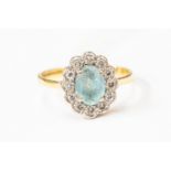 A blue zircon and diamond ring, central oval aquamarine with a diamond set surround, and 18ct gold,