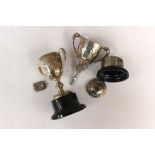 Two silver trophies, (on stands) with a silver pendant, (one trophy and pendant weighing approx. 1.