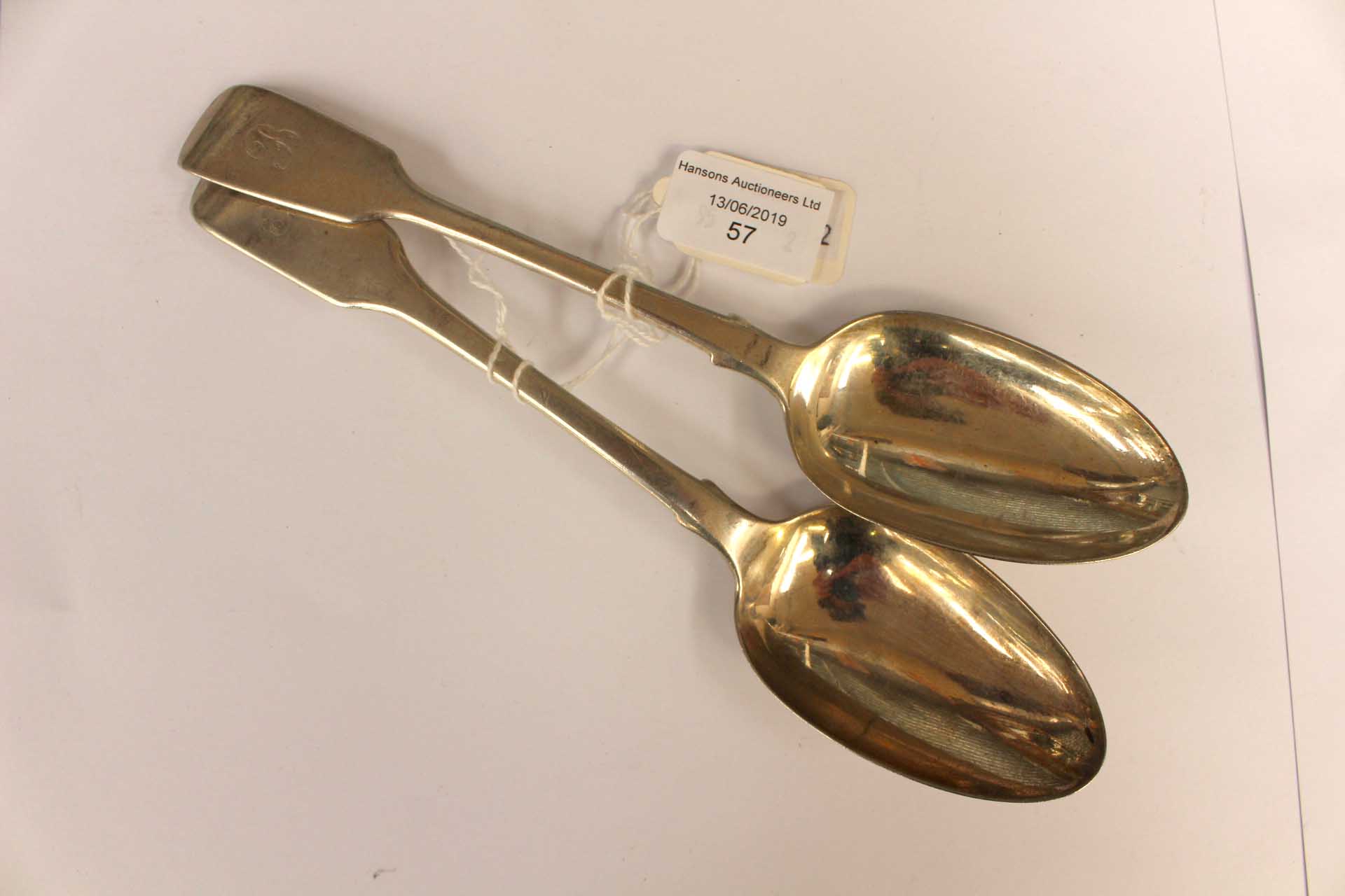 A matched pair of early Victorian silver table spoons, hallmarked for London 1840 and 1860,