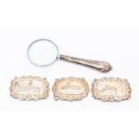 Silver bottle labels including Whiskey, Gin and Sherry, along with a plated magnifying glass,