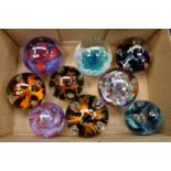A collection of nine Caithness glass company paperweights including Diabolo;