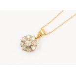 A diamond and unmarked 18ct gold pendant, the central stone approx 0.