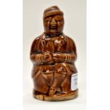 A Victorian treacle glazed figural money box, possibly by Rockingham,