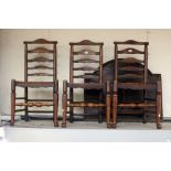 Three early 19th Century elm and beech ladderback chairs with solid seats..