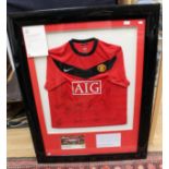 A signed and framed Manchester United 2009/10 home shirt,