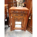 A 1980's reproduction chinese style mahogany nest of four carved tables.