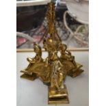 A brass comport base decorated with cherubs