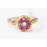 A 19th Century yellow metal ring, set with seed pearl and rubies, size N1/2,