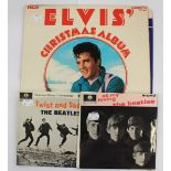 A collection of Elvis and The Beatles records, including Elvis Hits All my Loving,