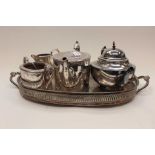 A late Victorian silver plated three piece part tea set having engraved Classical decoration,