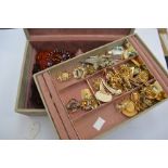 A jewellery box (with key) of assorted earrings, brooches,