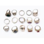 A collection of fifteen silver and white metal dress rings, some stone set,