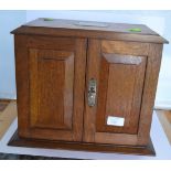 Early 20th Century oak writing box with two front opening doors and lift top with internal fittings