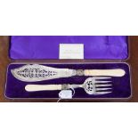 A late Victorian silver plated fish serving knife and fork, ivorine handles,