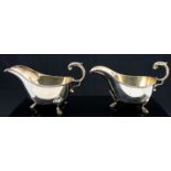 A pair of Edwardian silver sauce boats, George II style with C scroll acanthus handles,