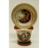 A rare Derby tea cup and saucer, gilded, each with a painted landscape, the cup titled 'Near Toledo,