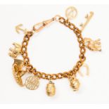 A 9ct gold charm bracelet containing 11 assorted charms, including a Viking ship,