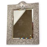 An Edwardian silver mounted easel shaped rectangular framed looking glass,