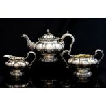 A George IV three piece silver melon form tea service, comprising teapot,