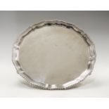 An Elizabeth II plain silver salver gadroon border on three scroll feet,