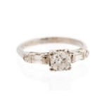 A diamond solitaire platinum ring, with diamond set shoulders,