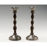 A pair of George V silver mounted candlesticks with oak twisted stems,