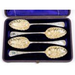 A Victorian set of four silver berry spoons, the handles engraved with foliage,