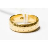 An 18ct gold wedding band, decoration worn to outer, engraved to interior, size M½,
