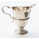 A George V helmet shaped silver cream jug, London, 1921, maker's mark rubbed, 4.14ozt (128.