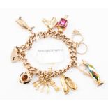 A 9ct gold charm bracelet with eight assorted 9ct gold and yellow metal charms and a padlock