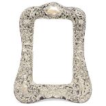 An Edwardian silver chased table easel mirror, London 1902,