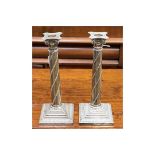 A matched pair of Victorian silver column candlesticks,