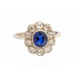 A sapphire and diamond oval cluster white gold ring,