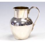 A late Victorian silver jersey can milk jug, the handle with floral terminal, Mappin & Webb,
