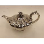 A George IV silver melon shape teapot, footed,