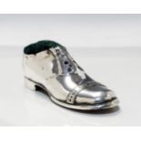 An Edwardian large silver Gentleman's shoe shaped pin cushion, with wooden base,