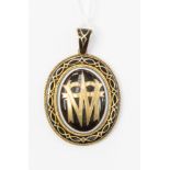 A Victorian mourning locket in yellow metal (tested 9ct) black enamel and with the initials M.
