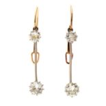 A pair of diamond and white metal drop earrings,