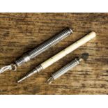 A collection of three Victorian Sampson Mordan & Company propelling pencils: two silver of fluted