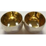 A pair of Modernist Britannia silver planished bowls, each with a gilt interior, Sheffield 2014,