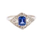An Art Deco style sapphire and diamond platinum ring, the central step-cut blue sapphire approx 0.