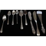 Collection of flatware including two butter knives and various spoons,