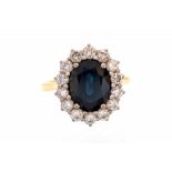 A sapphire and diamond oval cluster 18ct yellow gold ring,