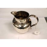 A Victorian silver helmet shaped Jersey style milk jug, reeded rim, mid rib and C-scroll handle,