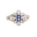 An Art Deco style sapphire and diamond platinum ring, the central step-cut sapphire approx 0.