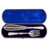 A pair of Victorian silver fish servers, the ornate handles with oval cartouches,