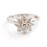 A diamond and 18ct white gold cluster ring,