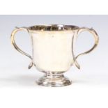 A George II Provincial plain silver loving cup, double scroll handles on spreading circular foot,
