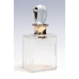 A George V silver mounted plain glass liqueur decanter and facet cut stopper,